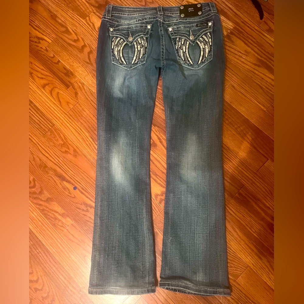 Miss Me jeans. Feathers on back pockets